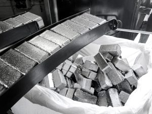 High density aluminum briquettes are ejected from the briquette press