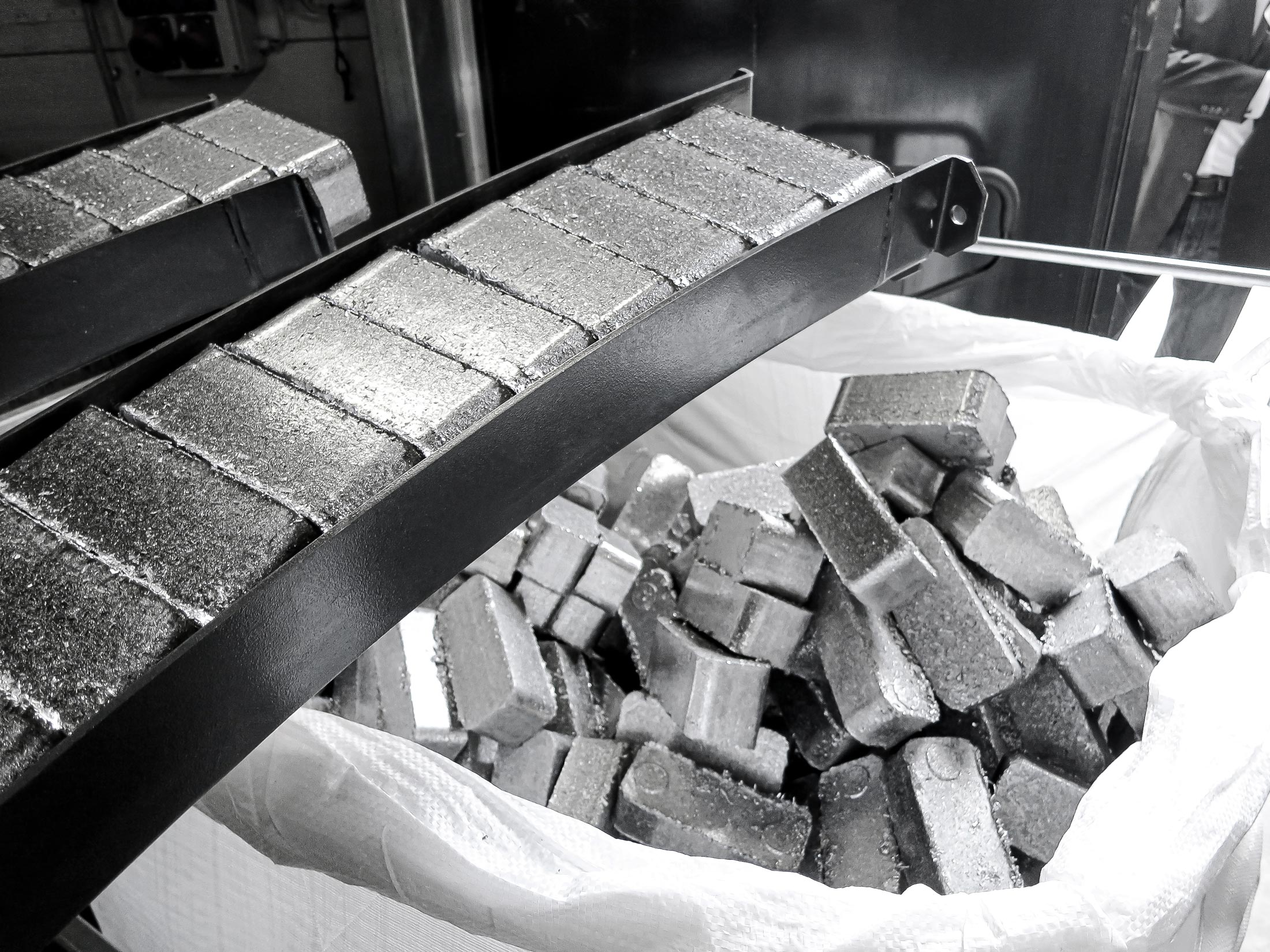 High density aluminum briquettes are ejected from the briquette press