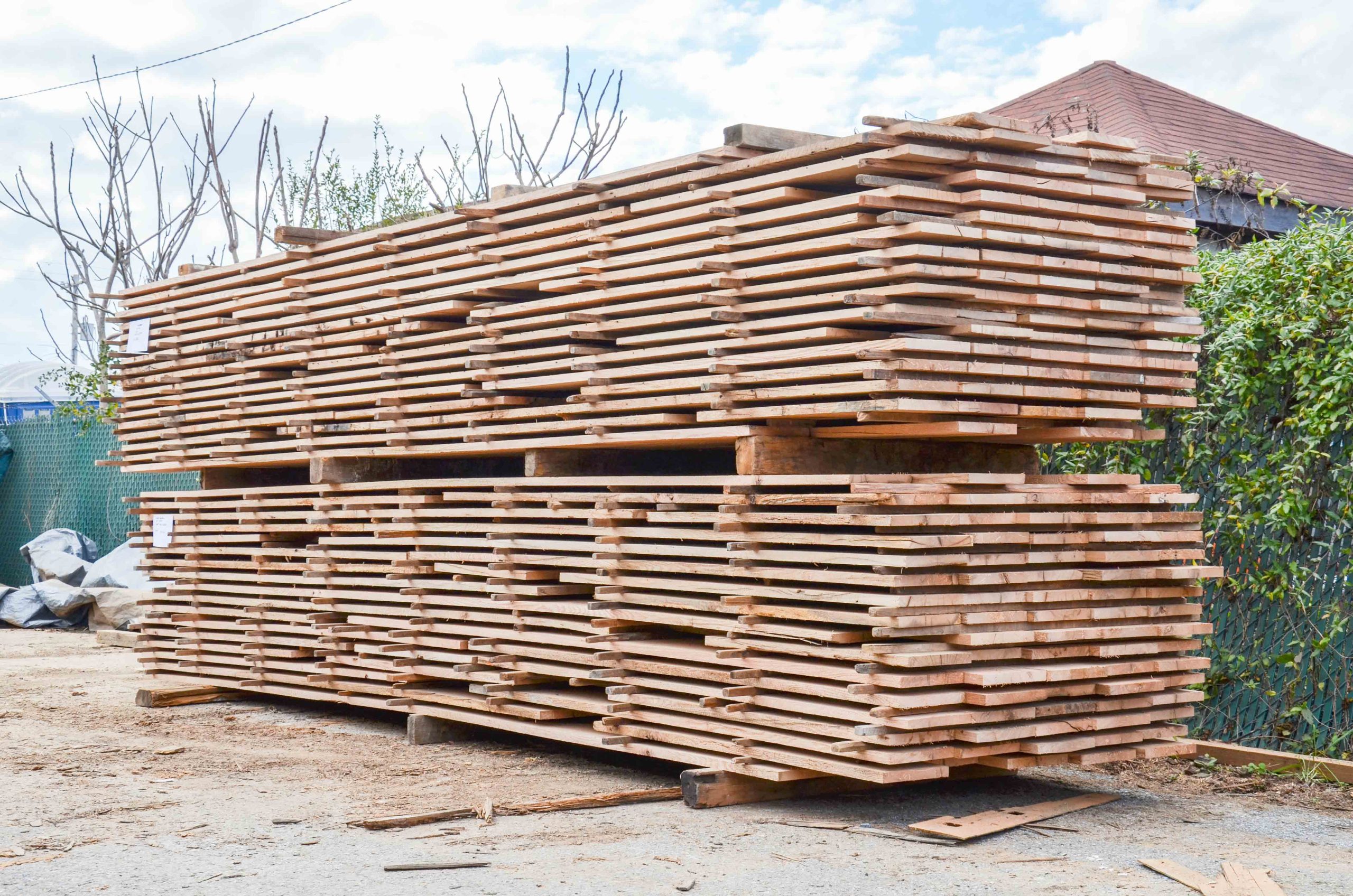 Stack with wooden planks before shredding with WEIMA machinery