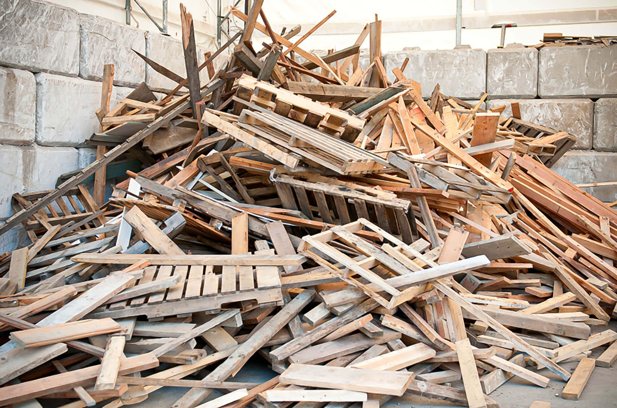 A pile of waste wood with wooden pallets and wooden furniture