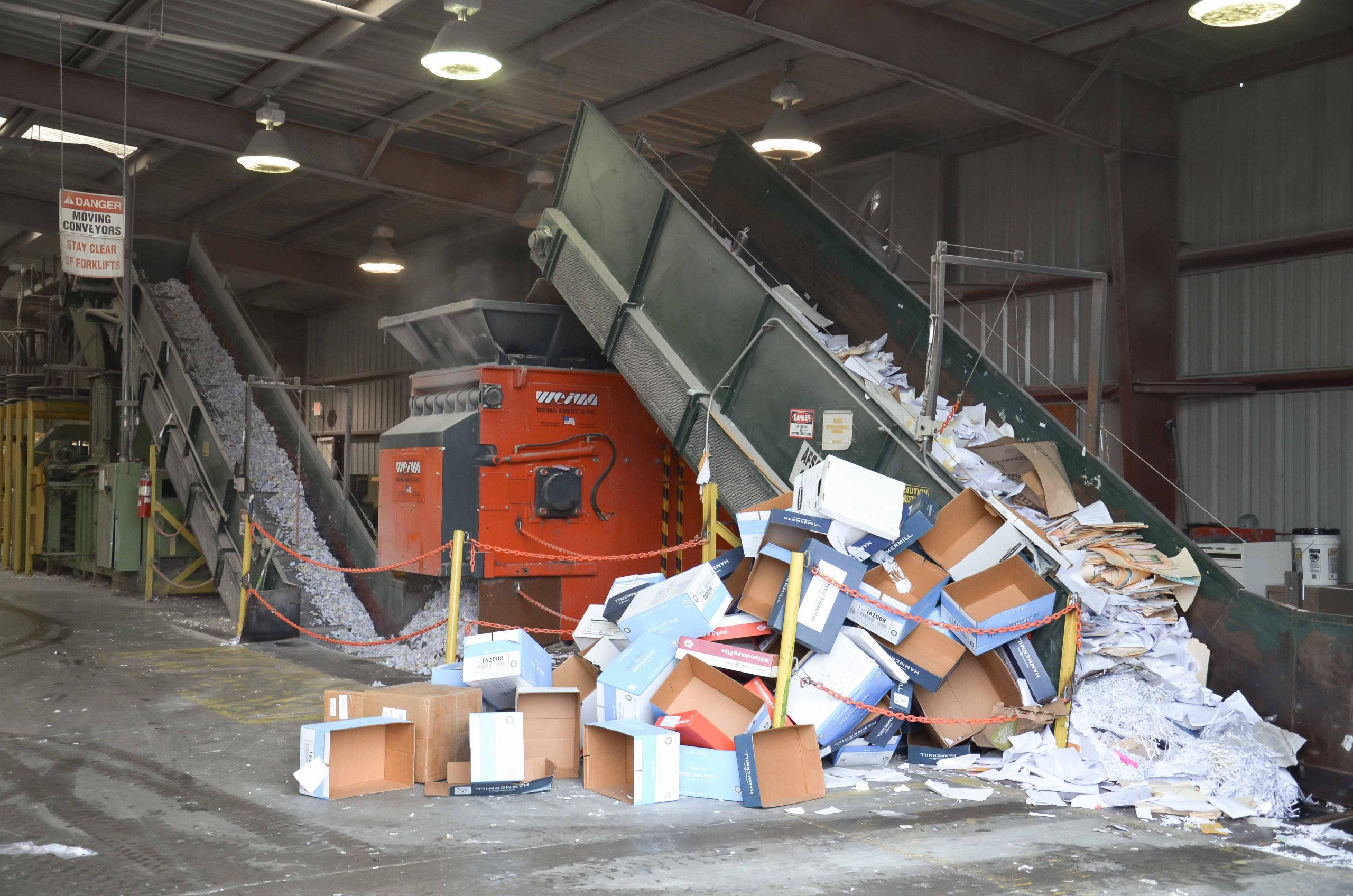Cartons and cardboard are fed by conveyor belt to the WEIMA shredder