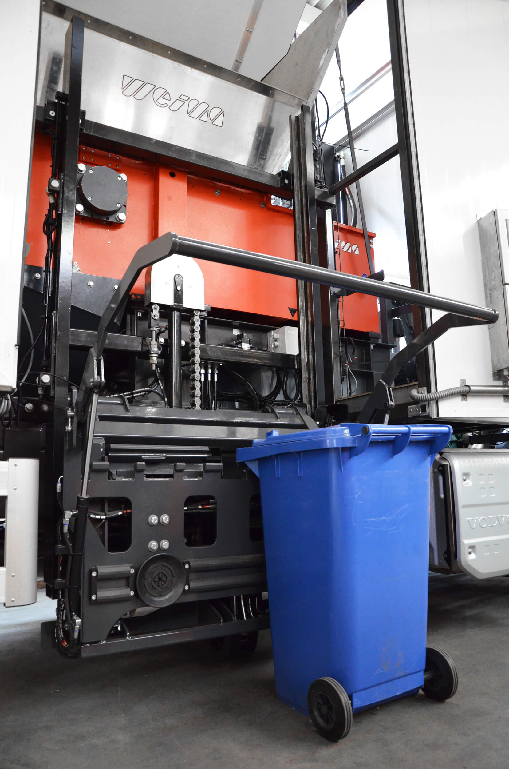 Paper waste garbage can is lifted with device to the mobile shredder