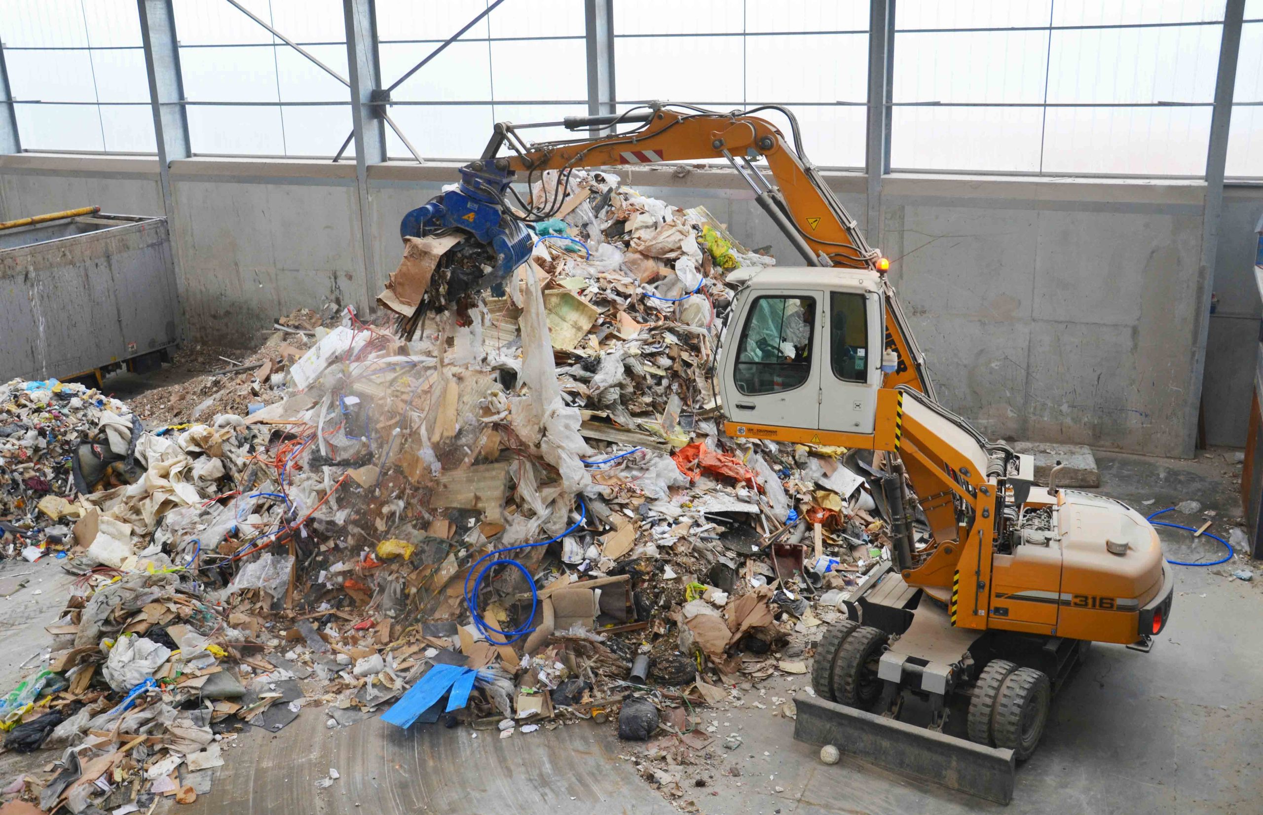 Bulky waste is put into the shredder with gripper