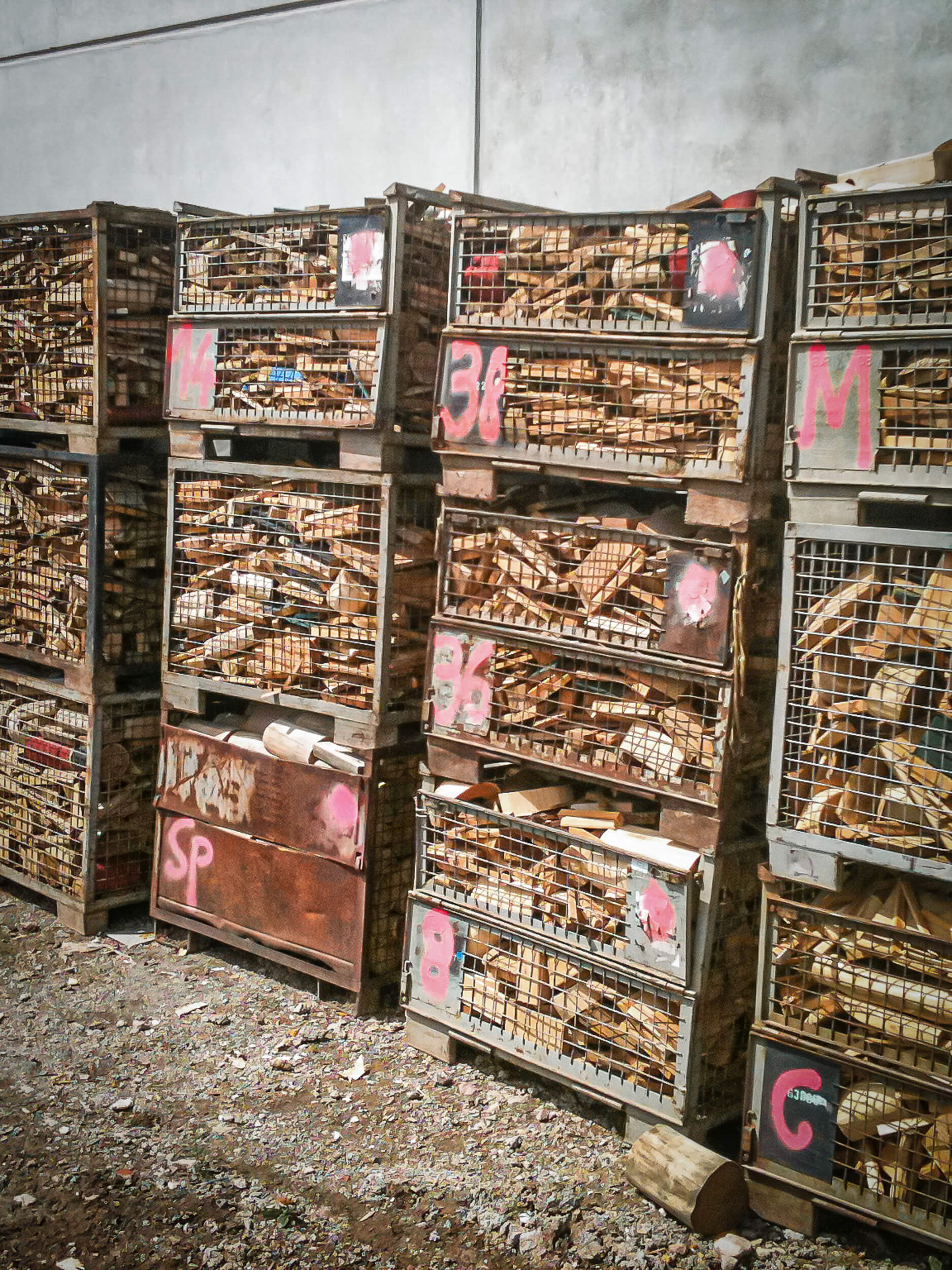 Wood scrap is kept in towers of lattice boxes before the shredding process