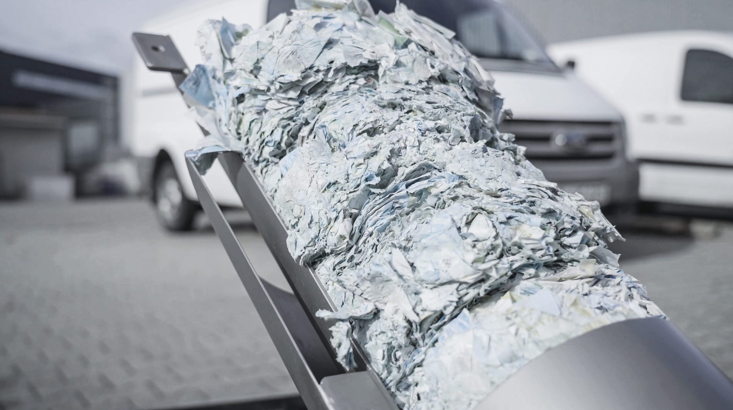 Compacted discs of paper labels are transported out of the PUEHLER machine