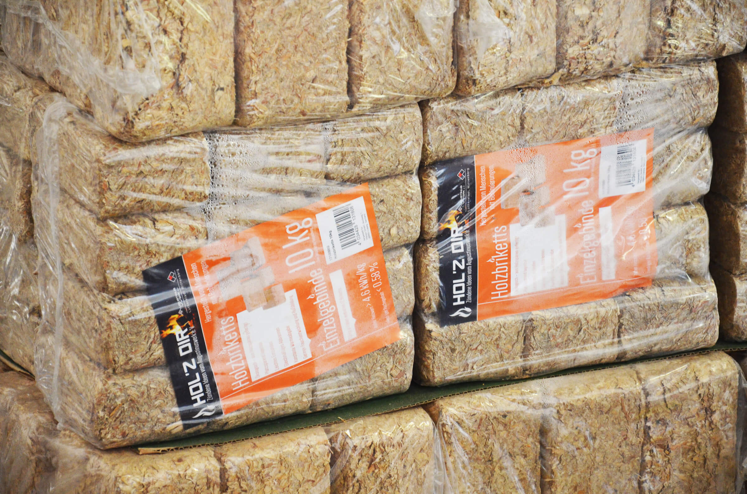 Stack of packaged wooden briquettes going on sale