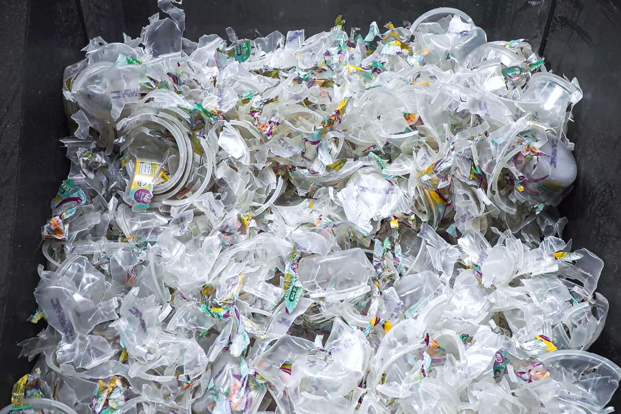hard plastic yoghurt cups in a shredder