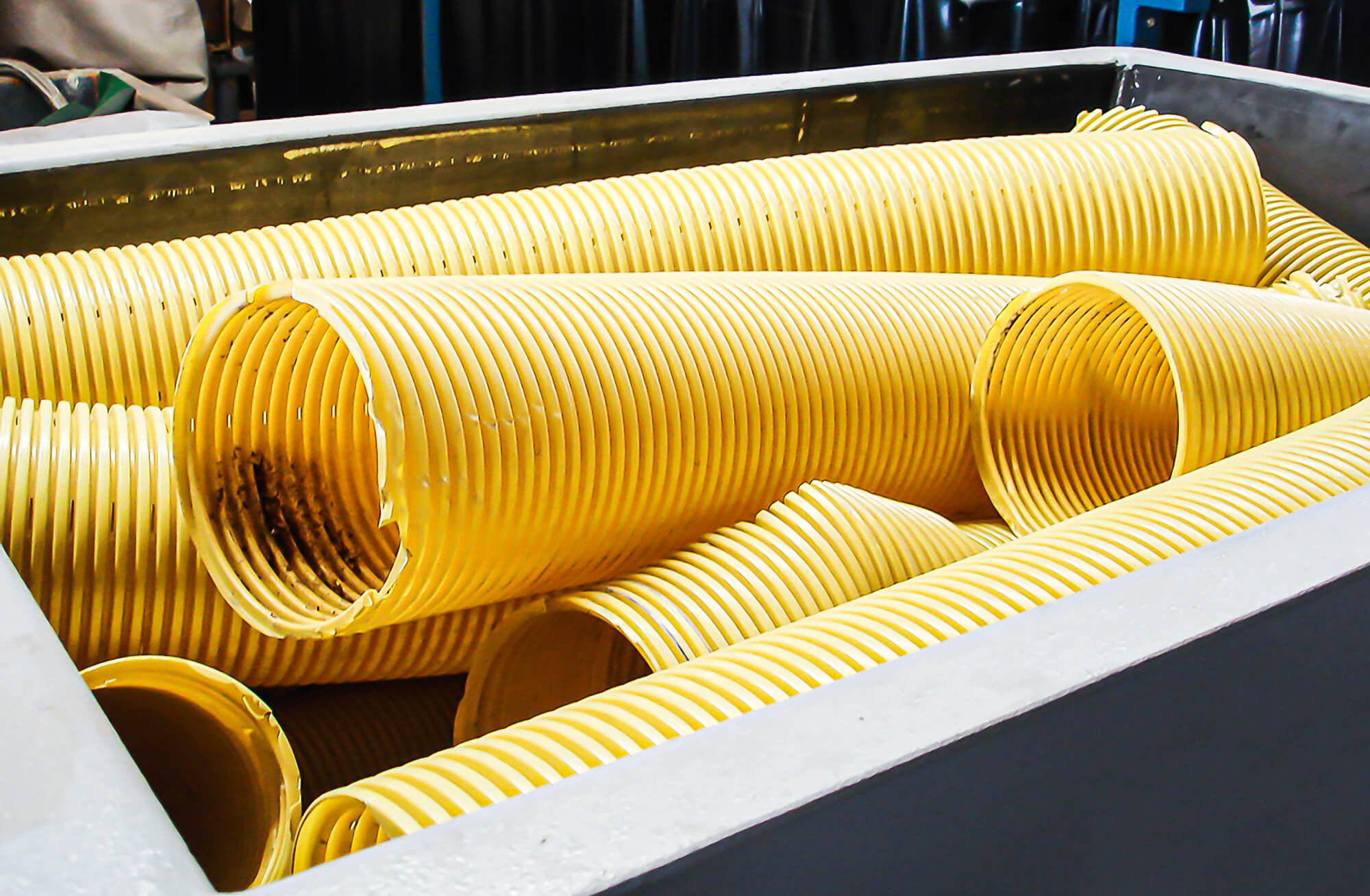 Polyvinyl chloride pipes are loaded into the WEIMA shredder