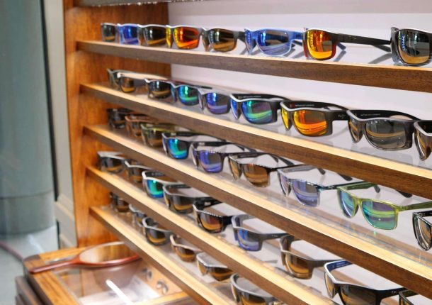 High-end Maui Jim sunglasses lined up on a display shelf in their showroom