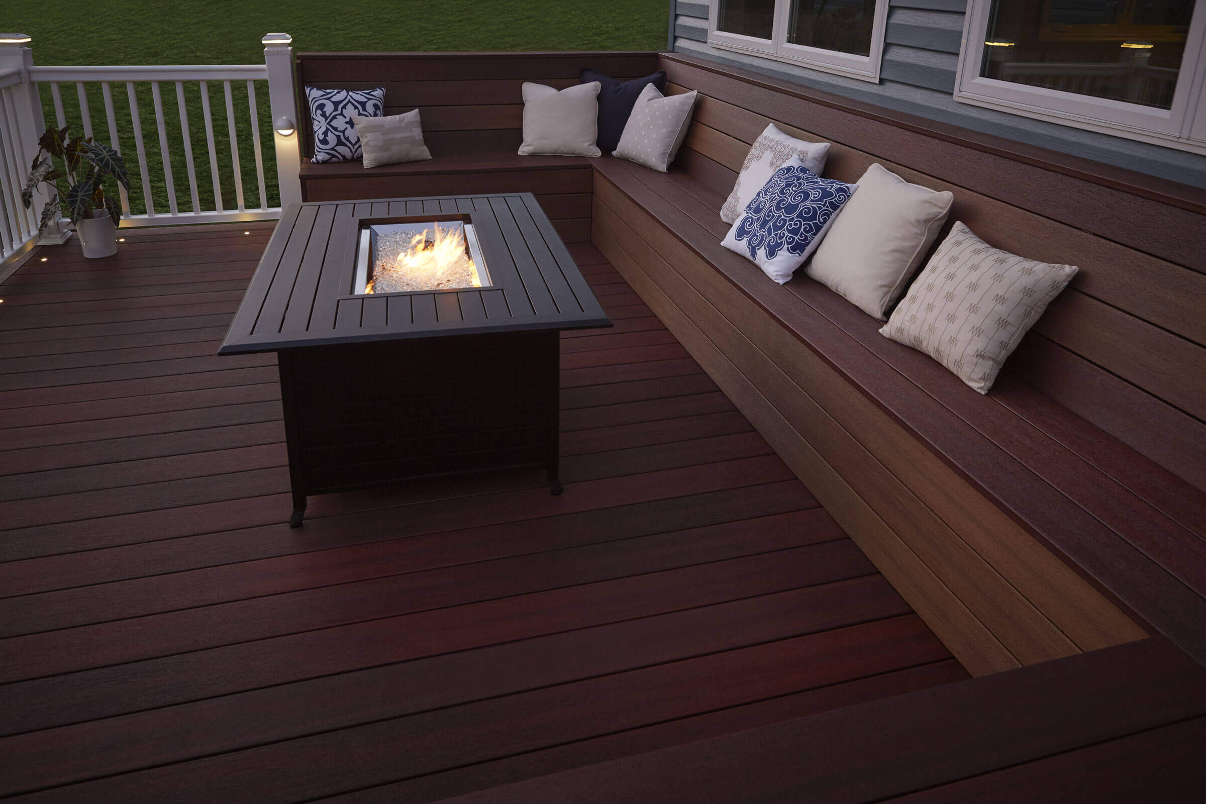 a gathering area on a porch with seating and a tabletop fireplace