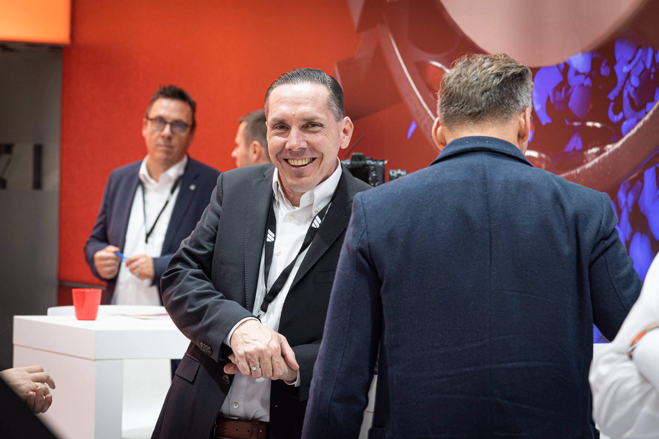 three smiling weima employees on the weima k show booth