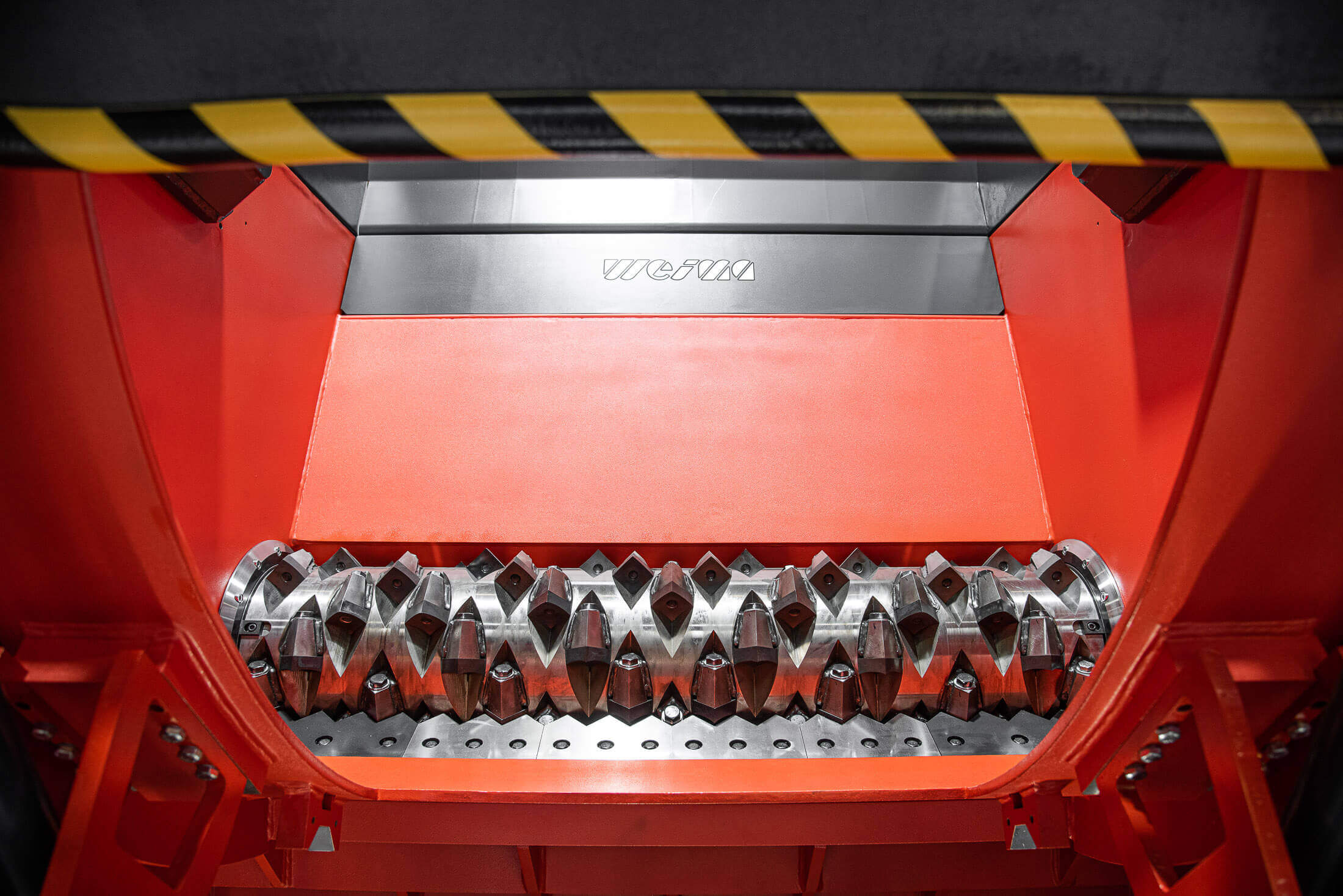 shredder rotor surrounded by orange machine housing