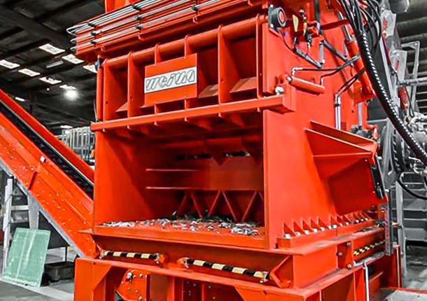 orange shredding machien from weima on concrete floor in production hall