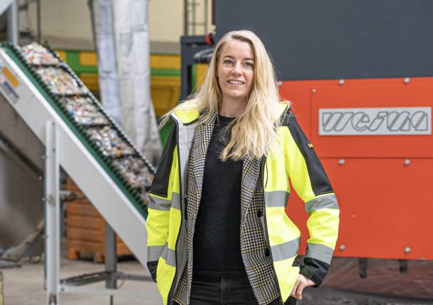 woman in front of a weima shredder