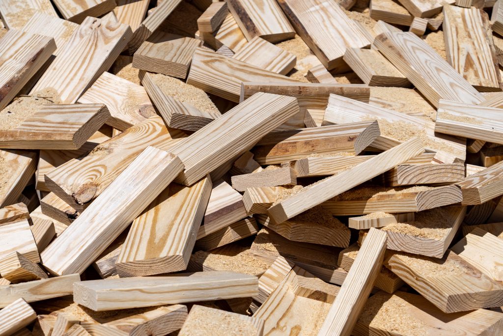 Bright pieces of scrap wood lie in a pile.