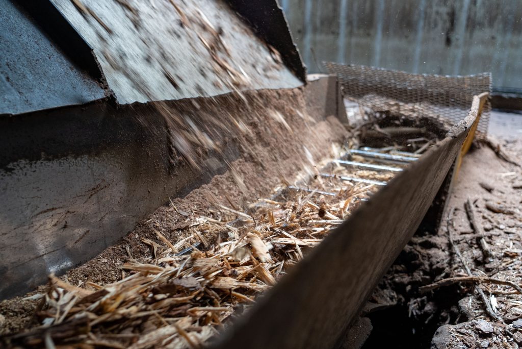 A machine is used to remove the bark from the tree trunks.