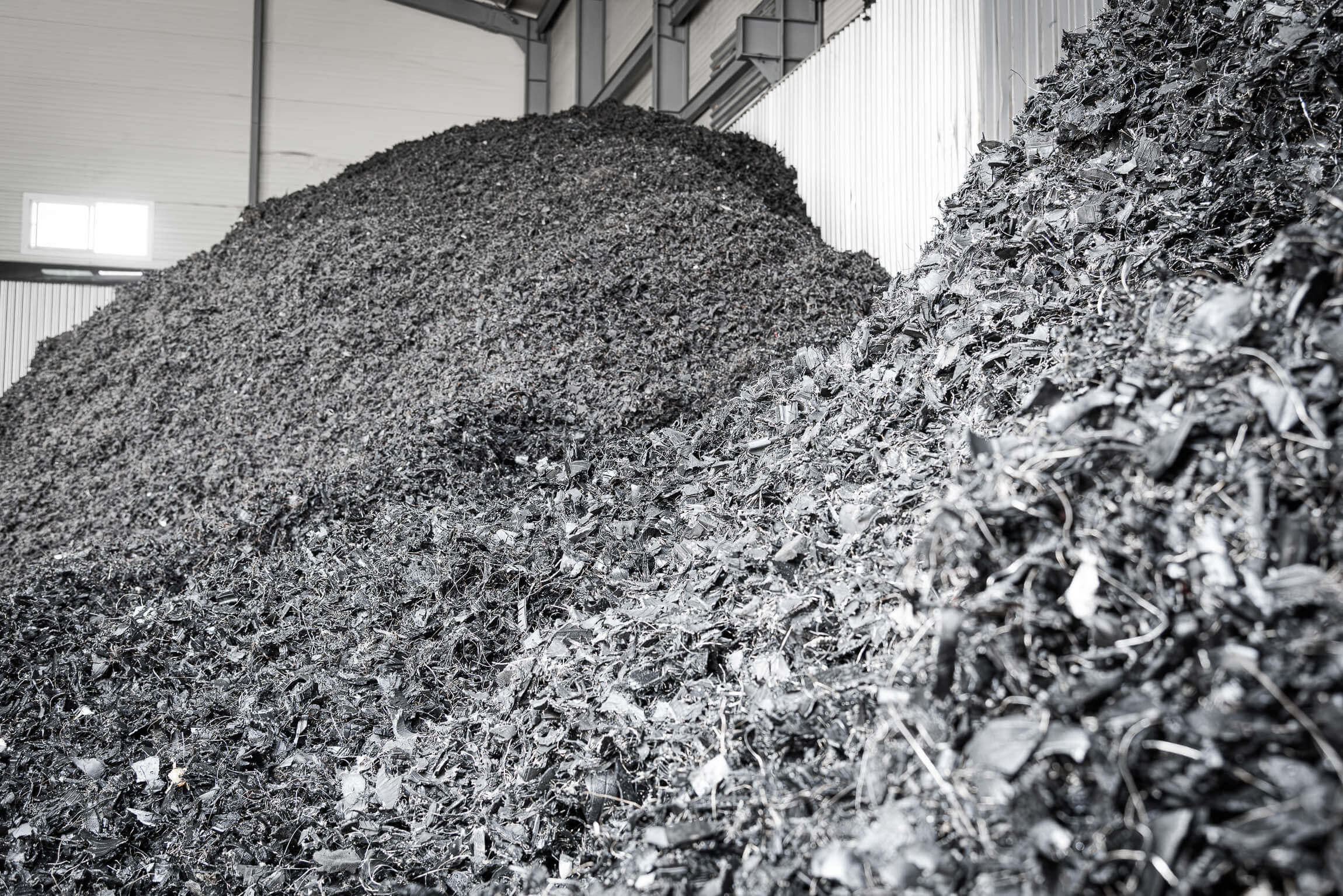 Shredded used tyres inside a recycling center