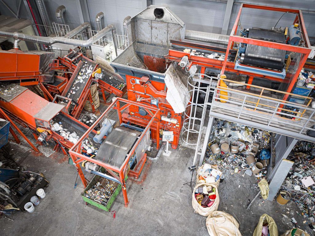 Aerial view of an orange shredder shredding municipal waste at a recycling company in South Korea