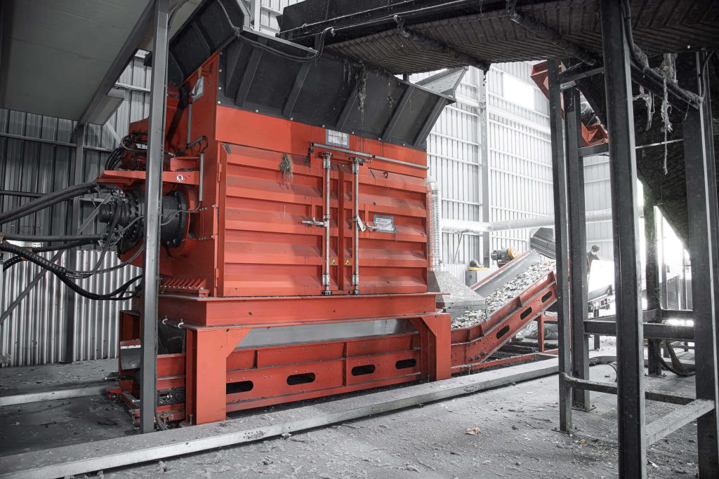 An orange shredder in South Korea shredding old textiles.