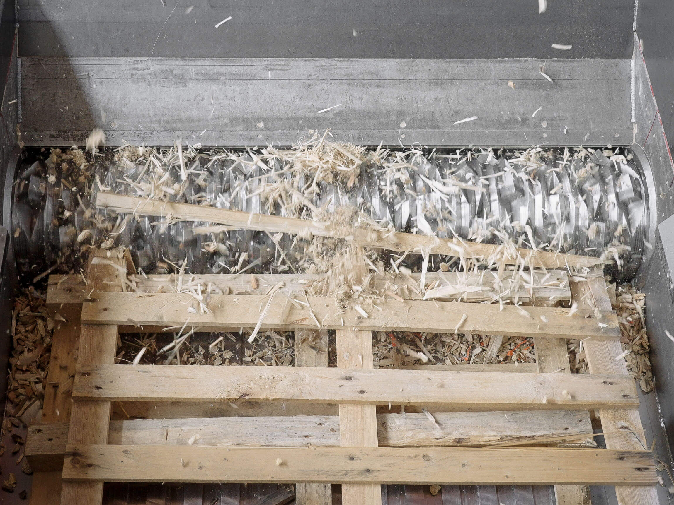 A pallet is shredded in the shredder.