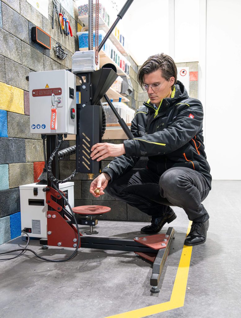 man prepares injection molding machine