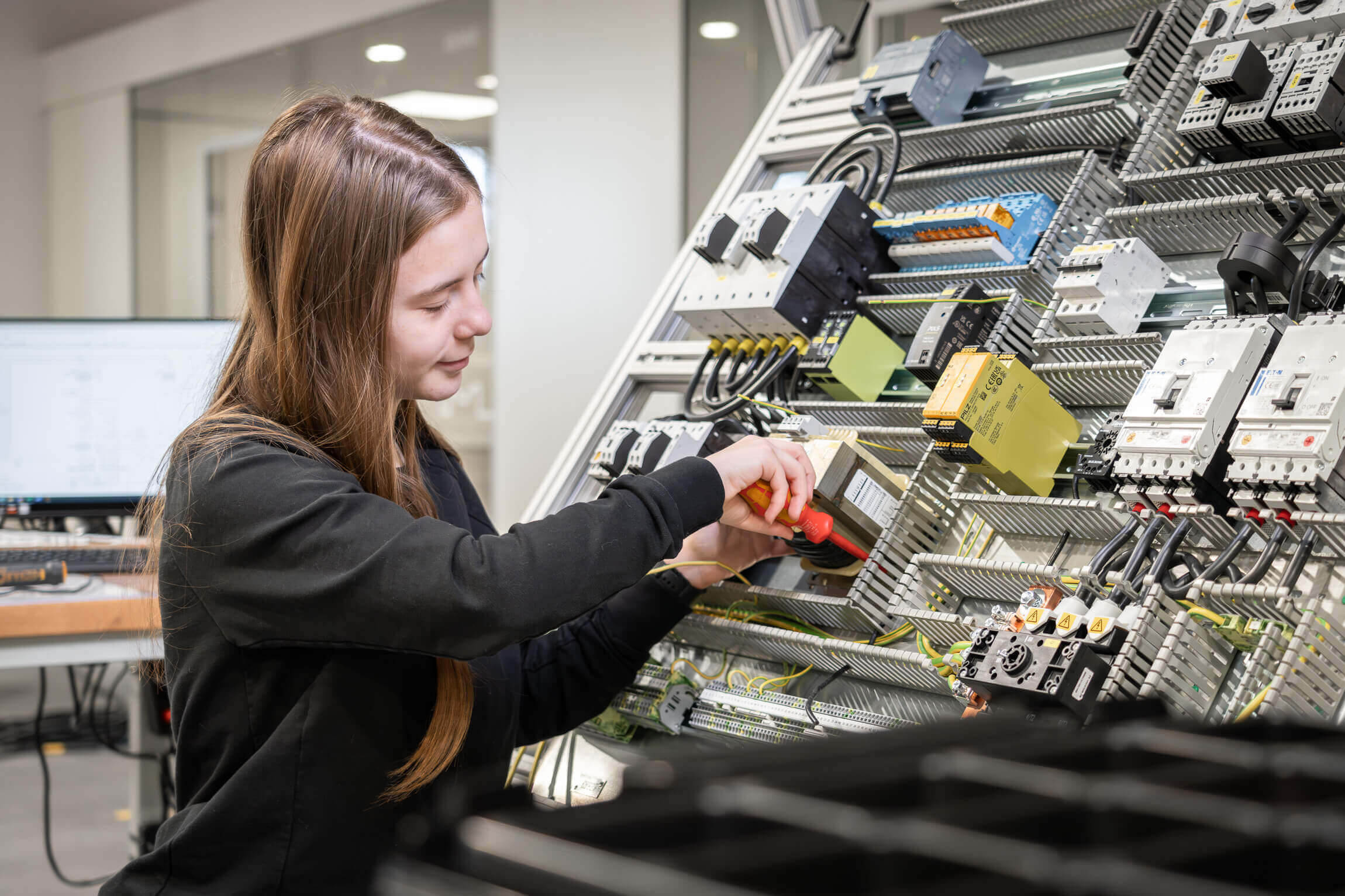 Female employee working on a WEIMA control cabinet