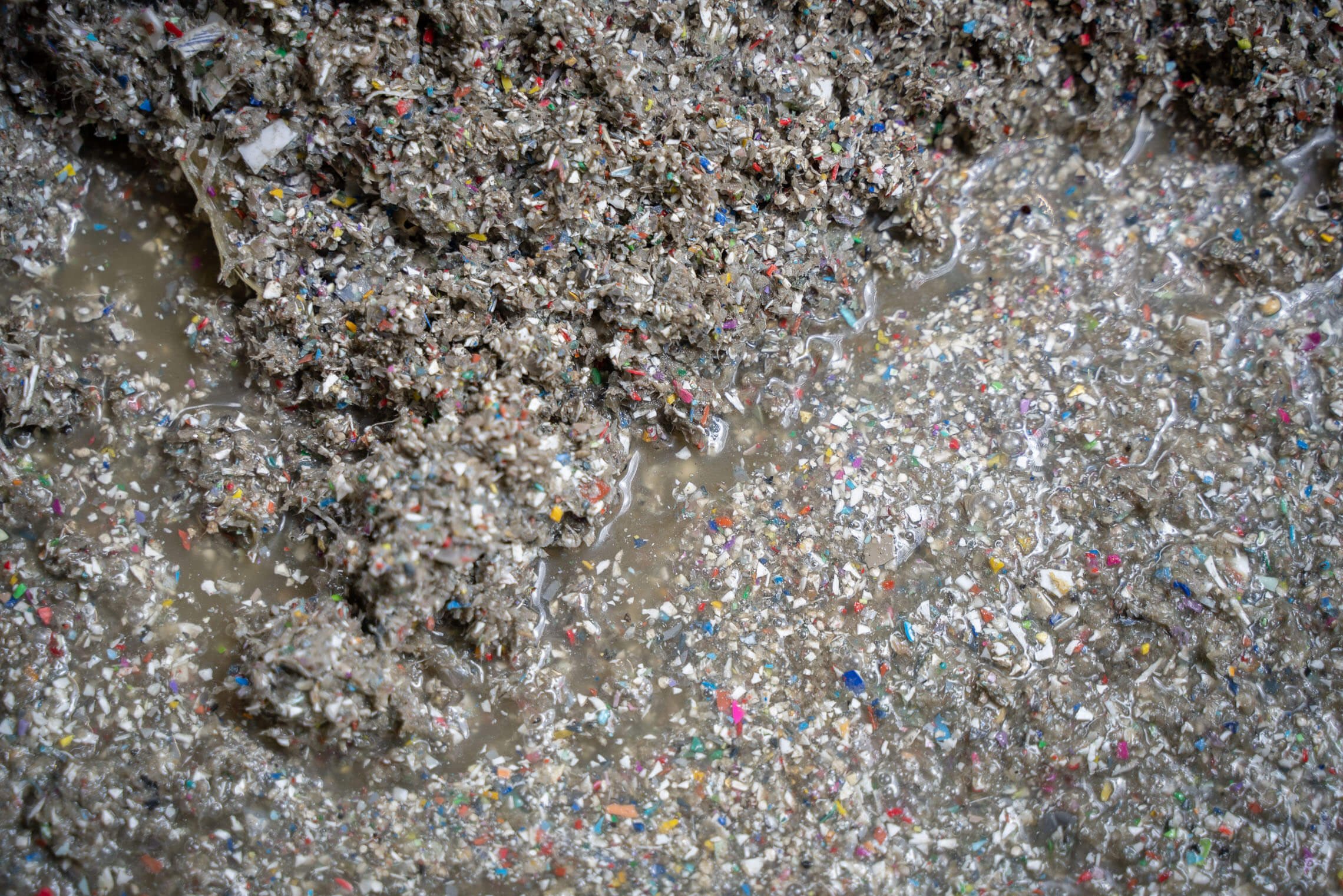 A pile of wet plastic fines in various colors