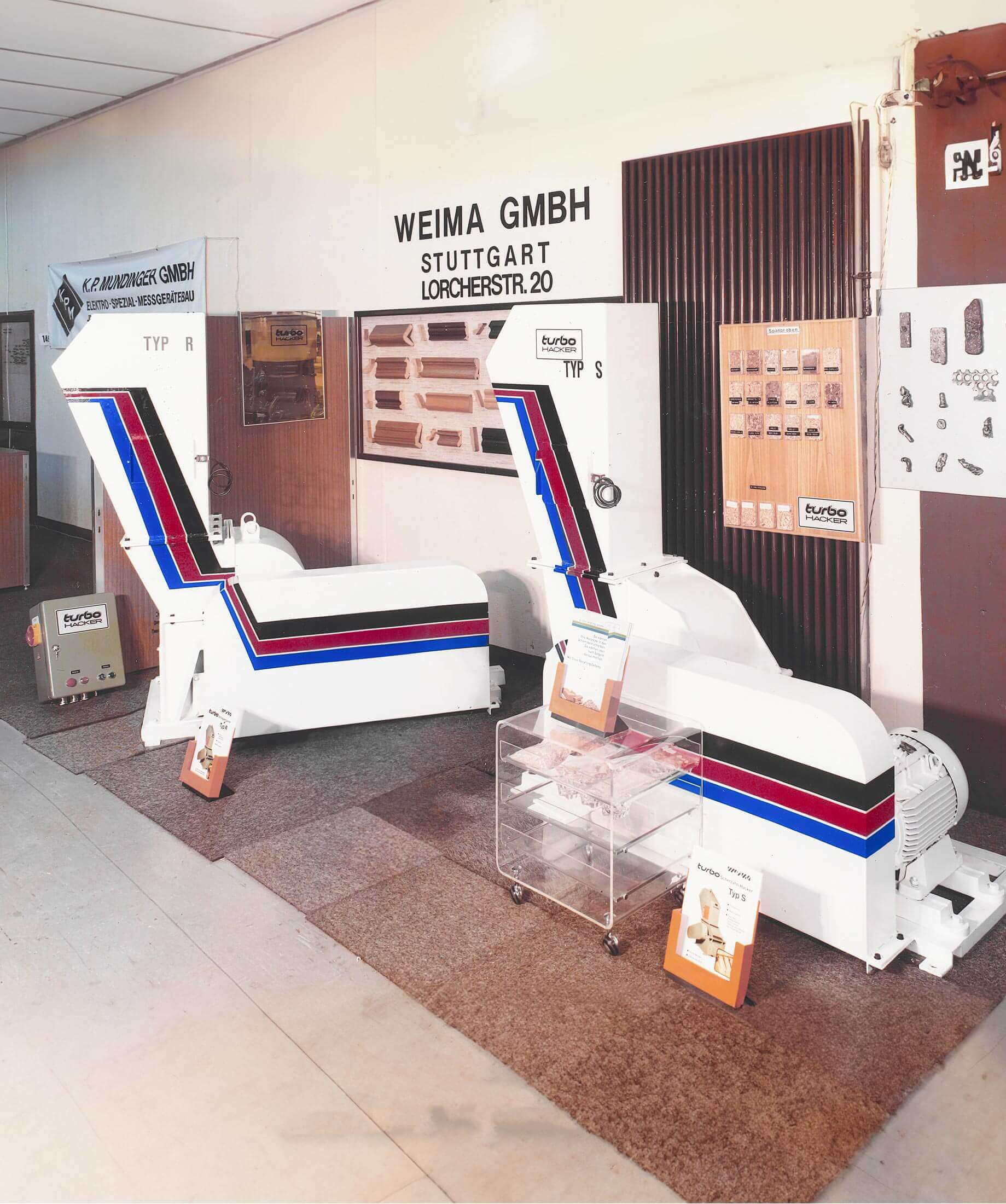 Historical photo of first WEIMA trade show in Stuttgart with two white WEIMA shredders