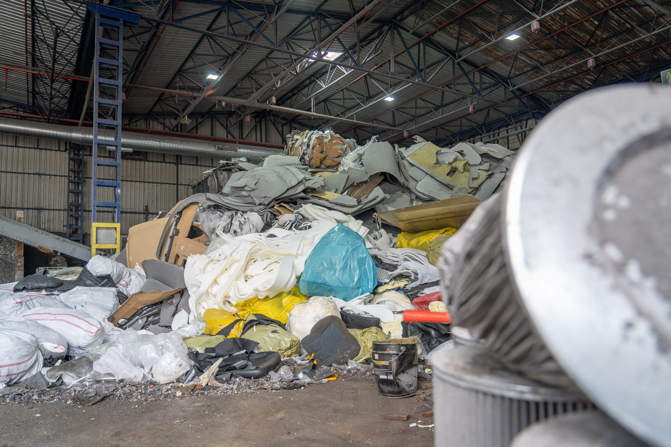 A large pile of industrial waste in a warehouse
