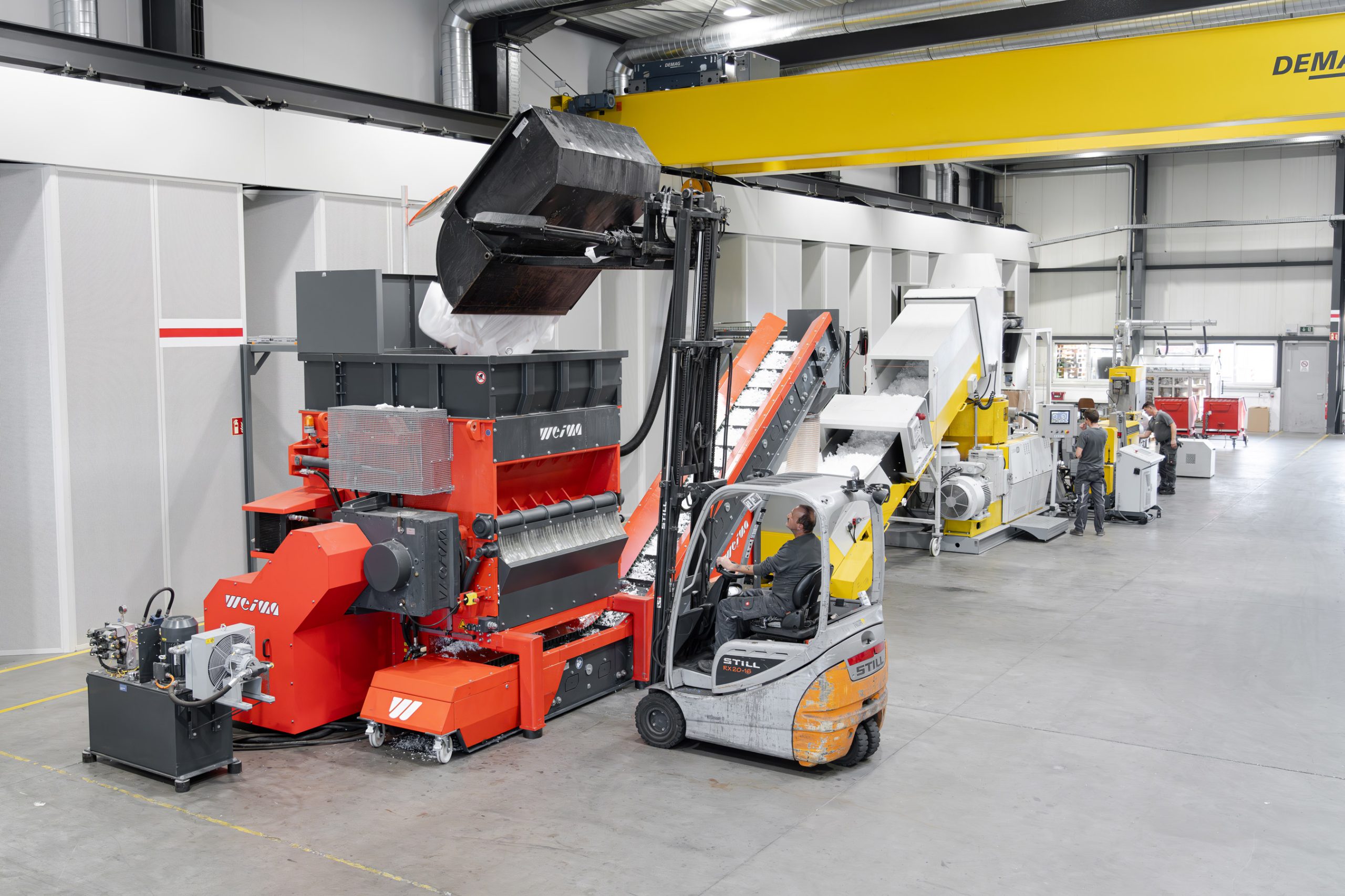 Orange WEIMA Plastic Shredder and NGR extrusion machine for plastic recycling in a production hall