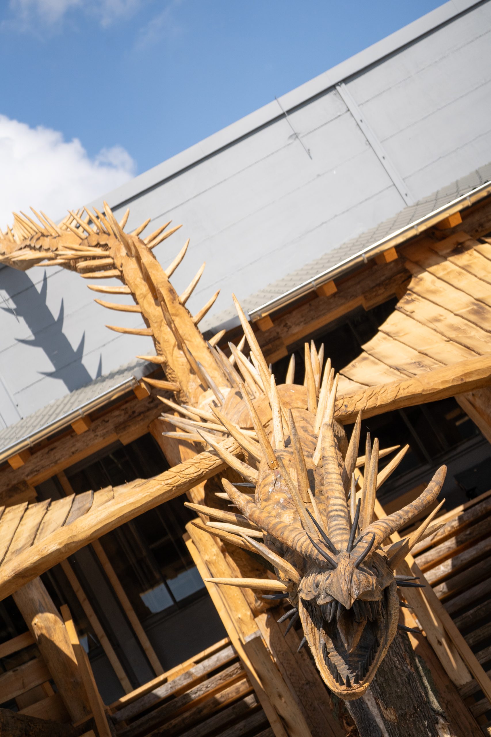 A wooden dragon above a staircase