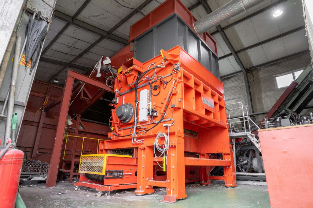 An orange shredder in a factory hall in South Korea