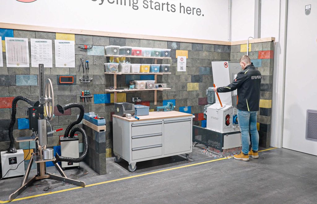 WEIMA plastic recycling workspace with shredder and injection moulding machine