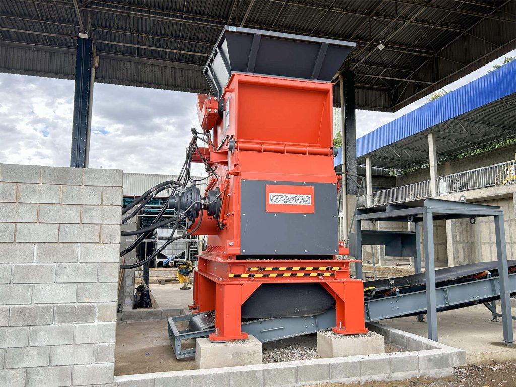 An orange shredder in a recycling plant