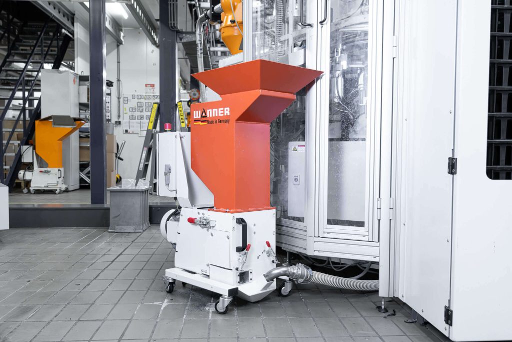 Wanner C-Series granulator next to a Record Industry press machine