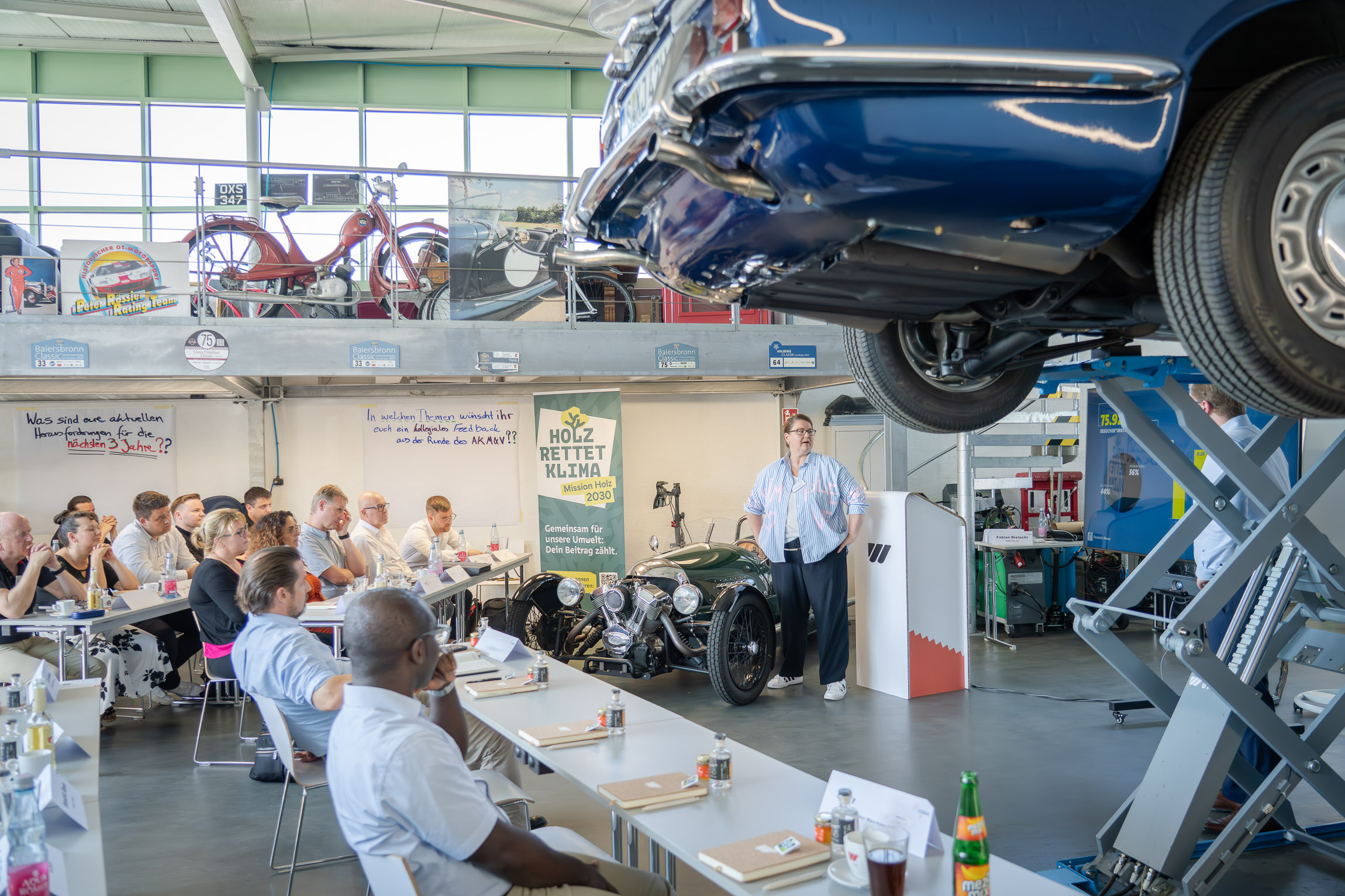 A woman gives a talk in the WEIMA Garage
