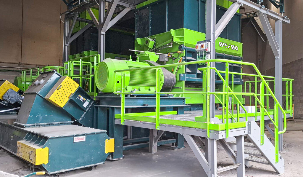 Two light green shredders in a warehouse.